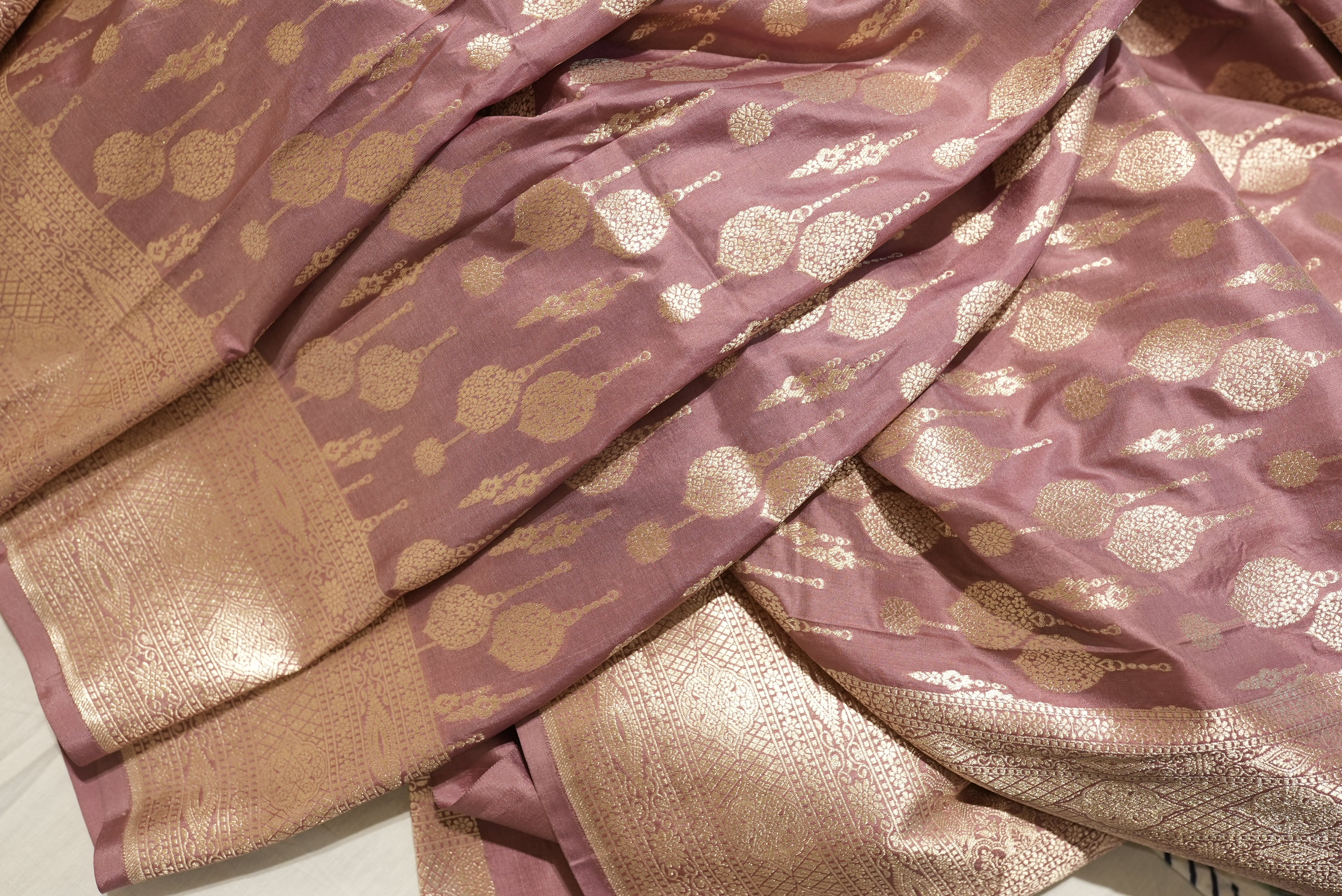 Peach banarasi saree with champagne gold zari boarder and motifs