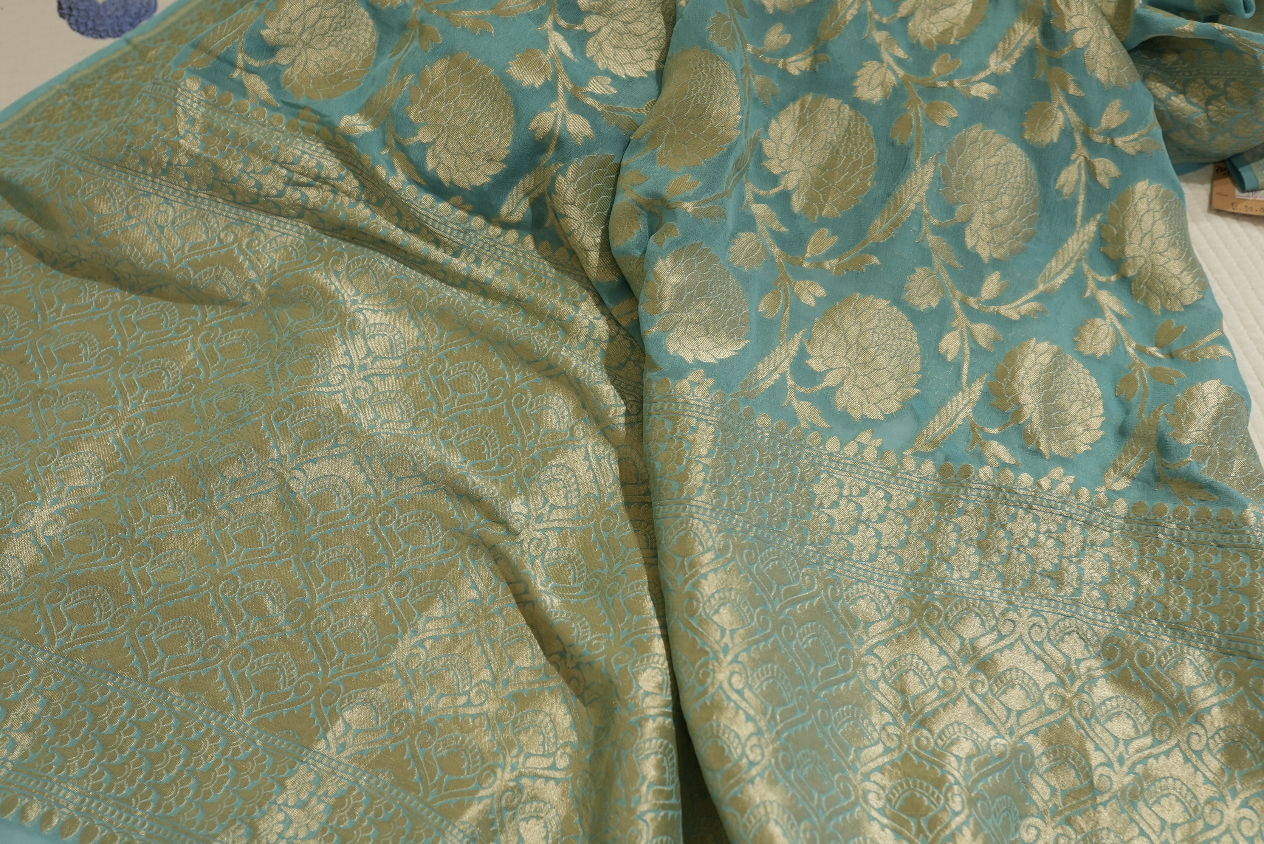 Sea green khaddi georgette saree with champagne gold zari full jaal work