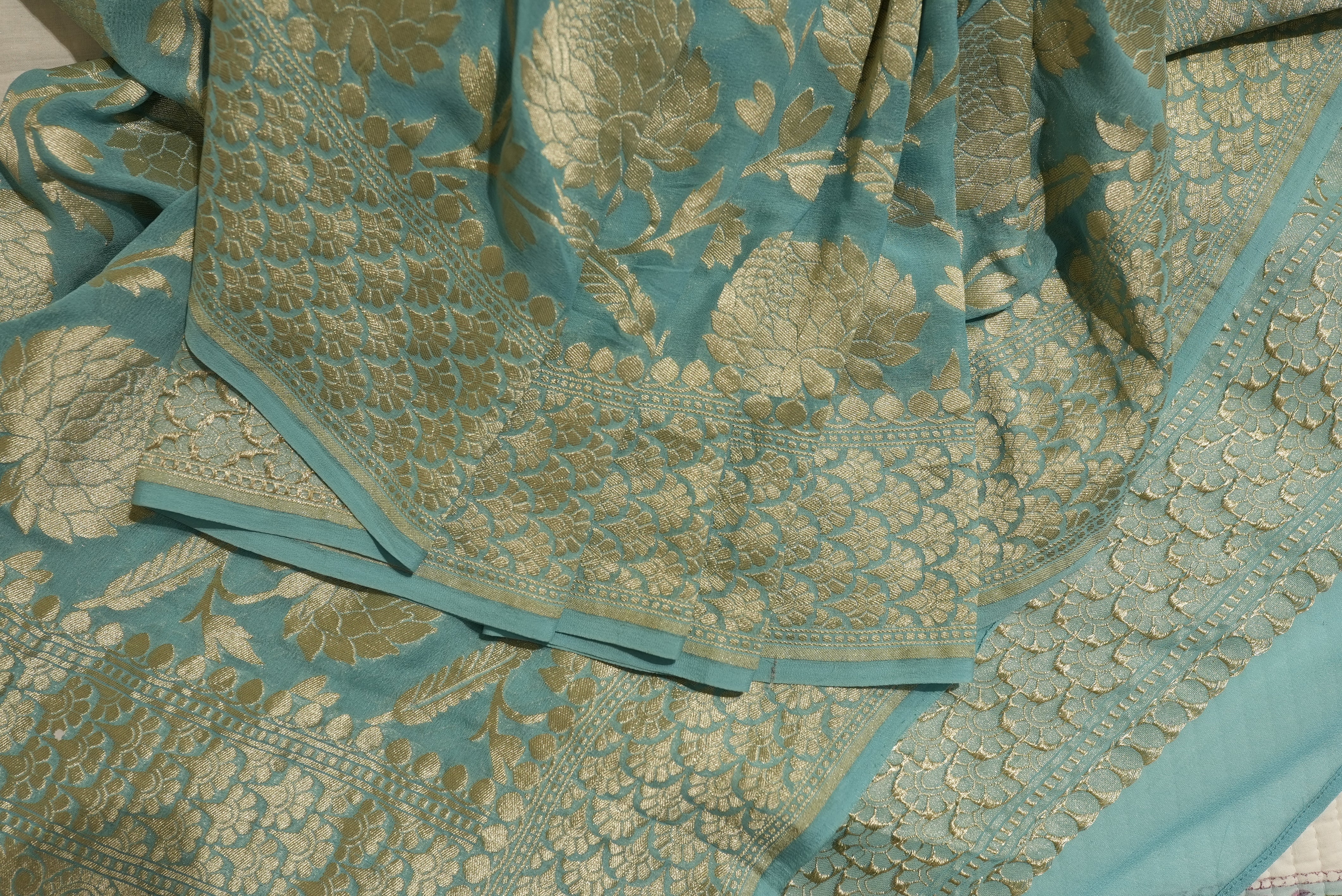Sea green khaddi georgette saree with champagne gold zari full jaal work