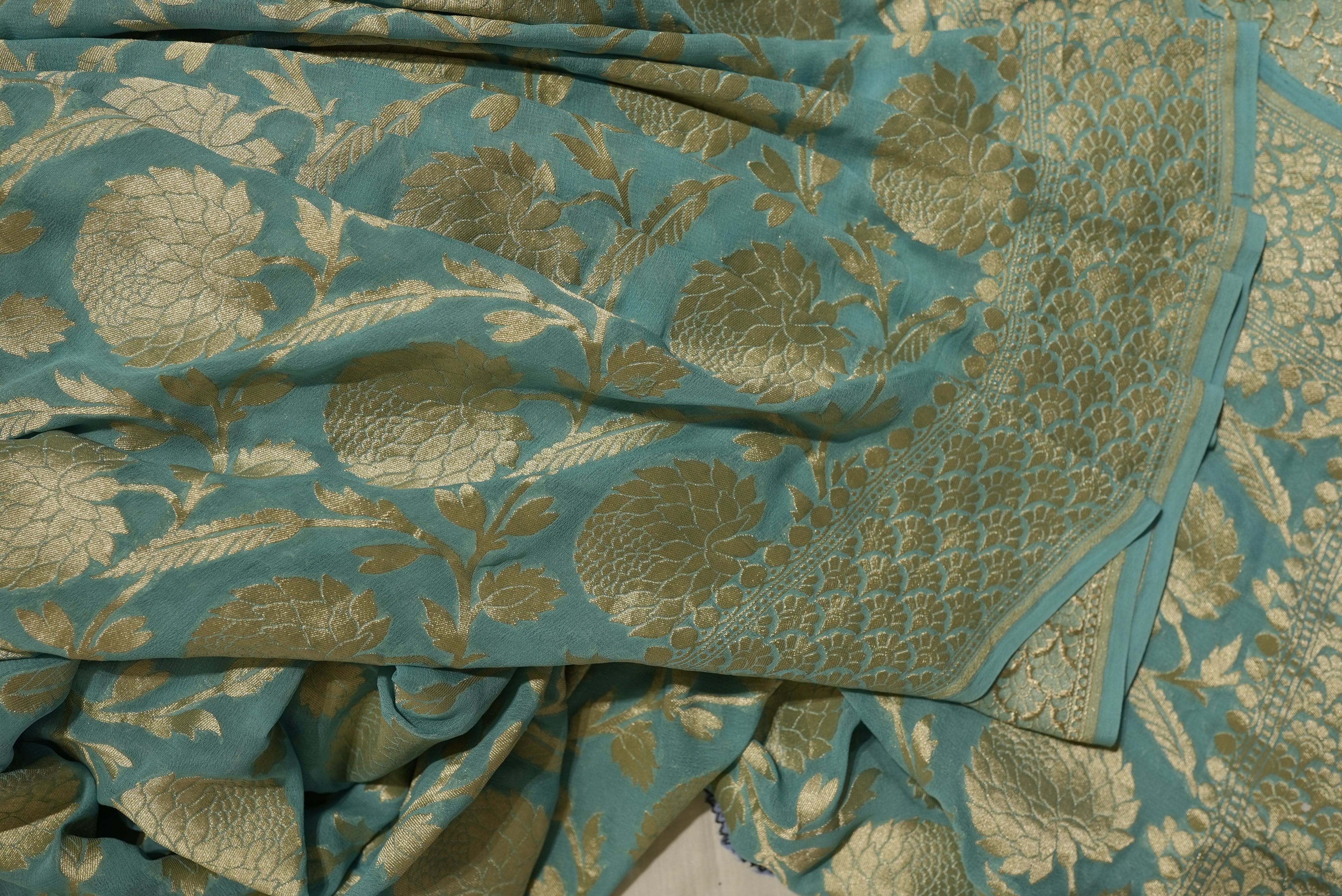 Sea green khaddi georgette saree with champagne gold zari full jaal work