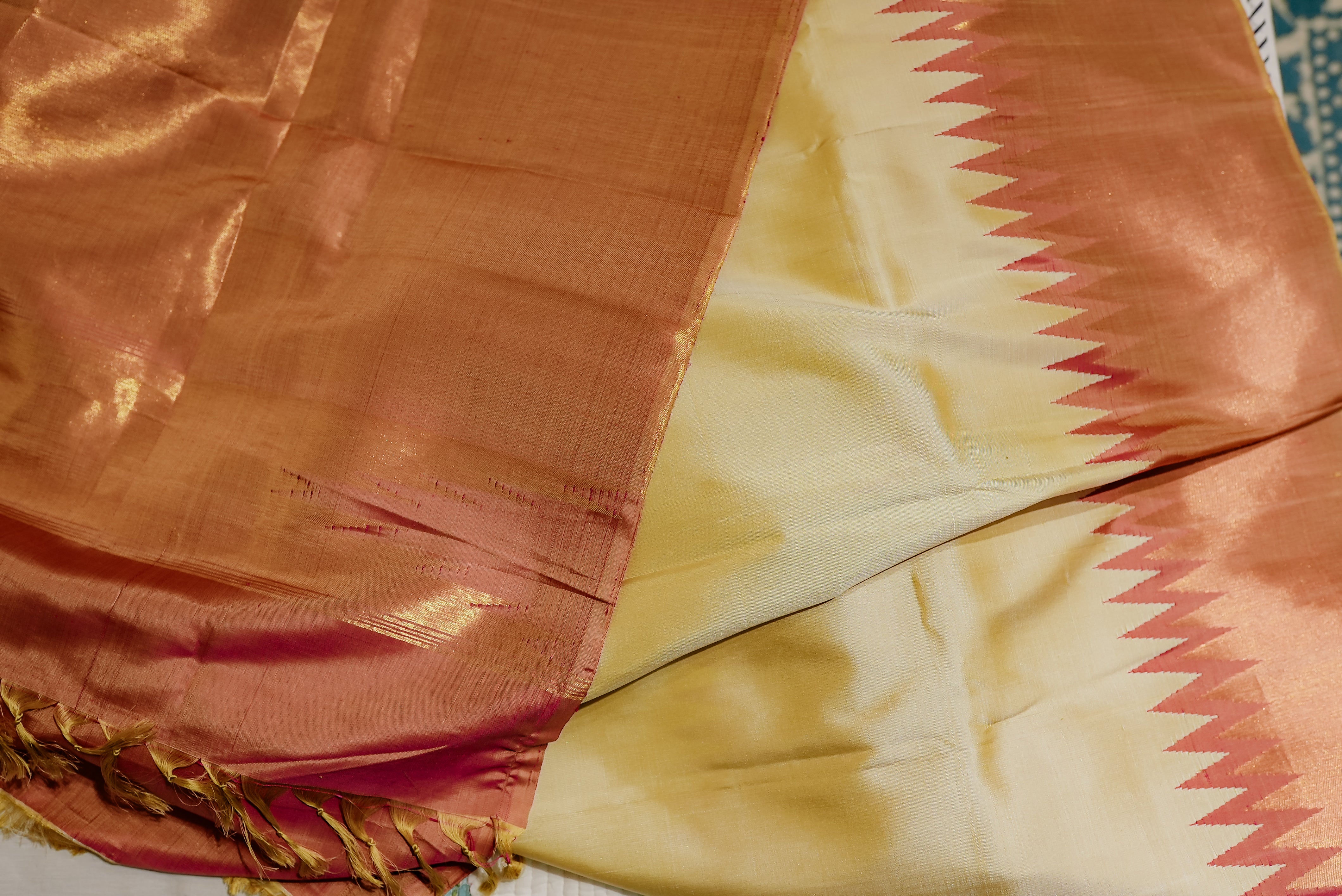 Beige kanjiwaram saree  with orange rising boarder