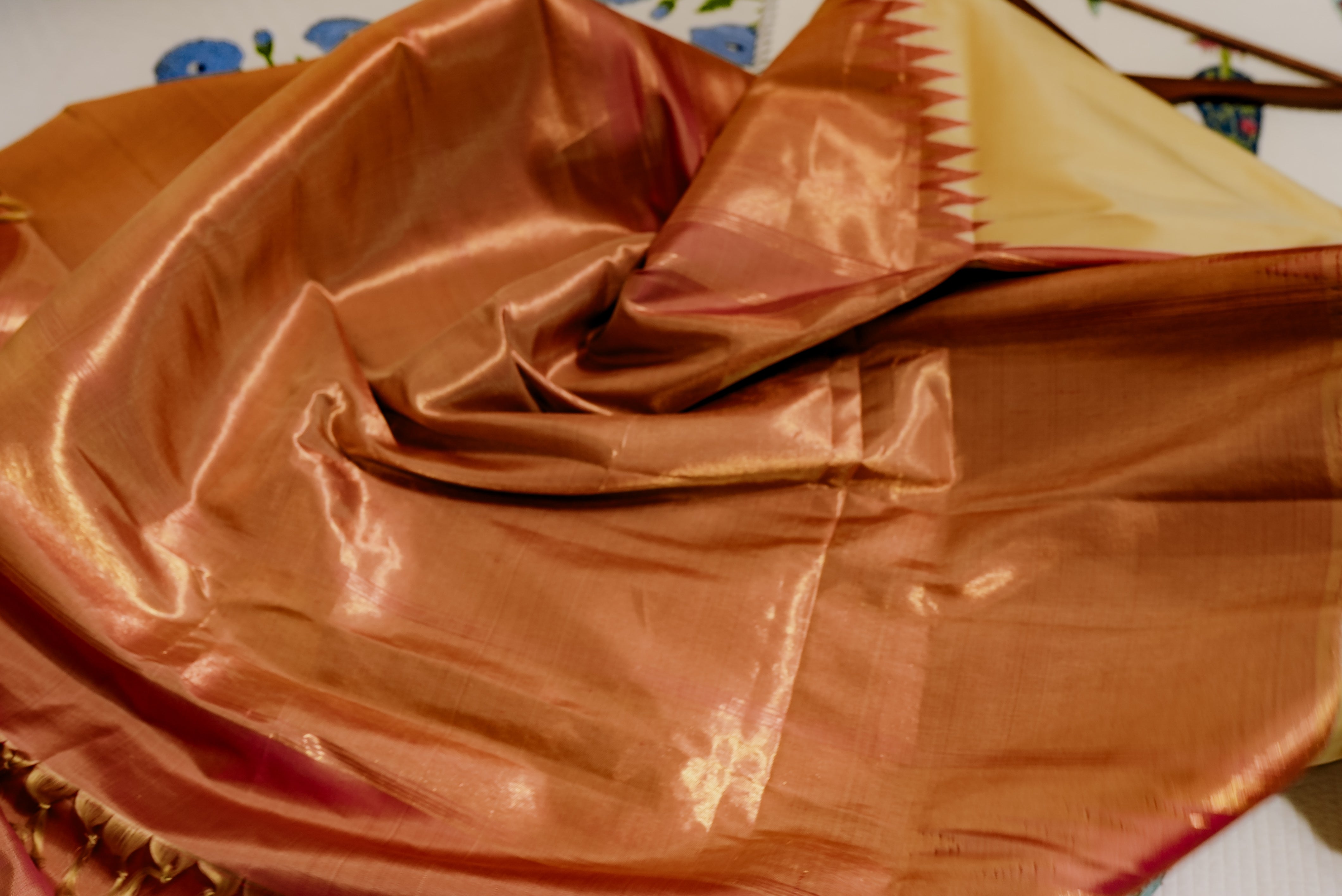 Beige kanjiwaram saree  with orange rising boarder