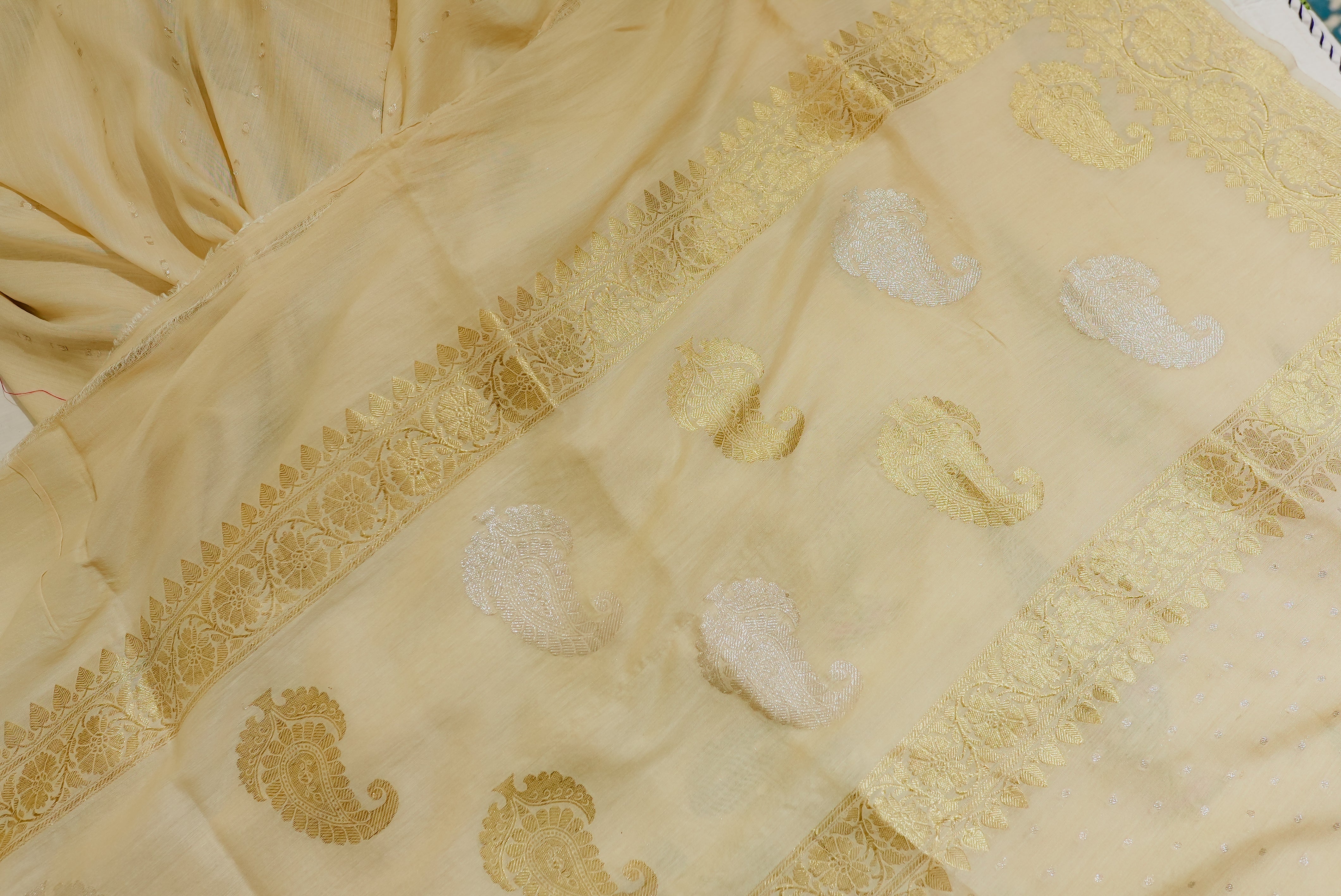 Beige moonga silk with golden but is and boarders