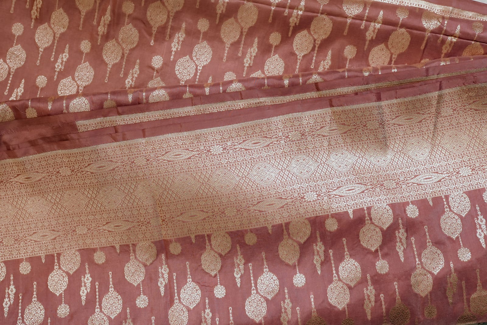 Peach banarasi saree with champagne gold zari boarder and motifs
