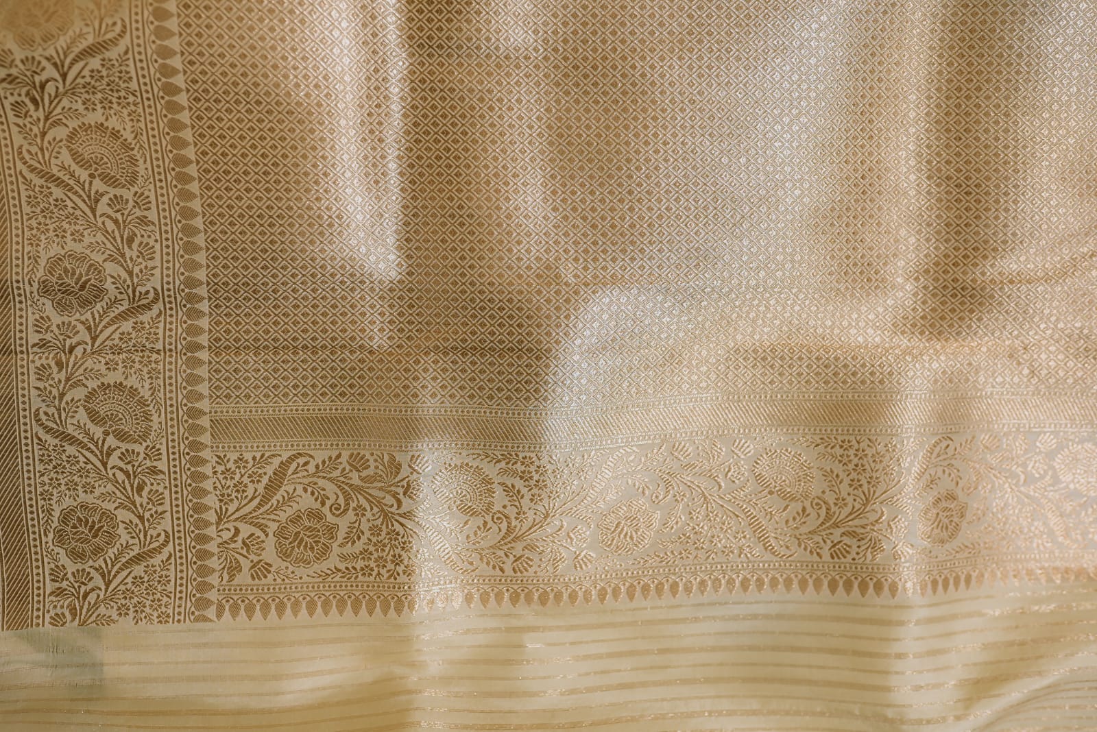 Beige banarasi saree with golden zari floral motifs